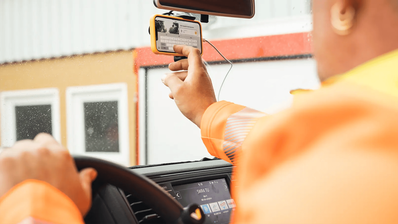 vialytics phone being used while being attached to the windshield of a car