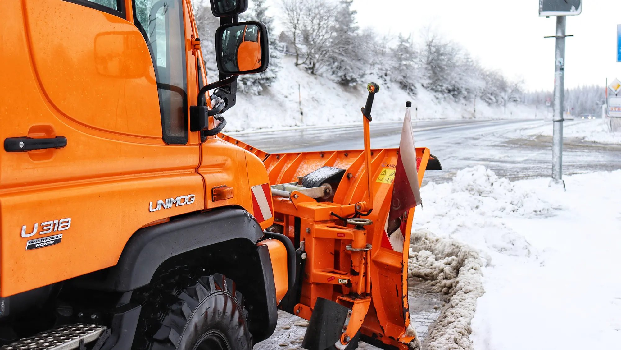 Snow clearing vehicle clears a snowy road