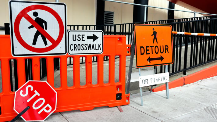 Sidewalk closed signs for public works, stop and detour signs