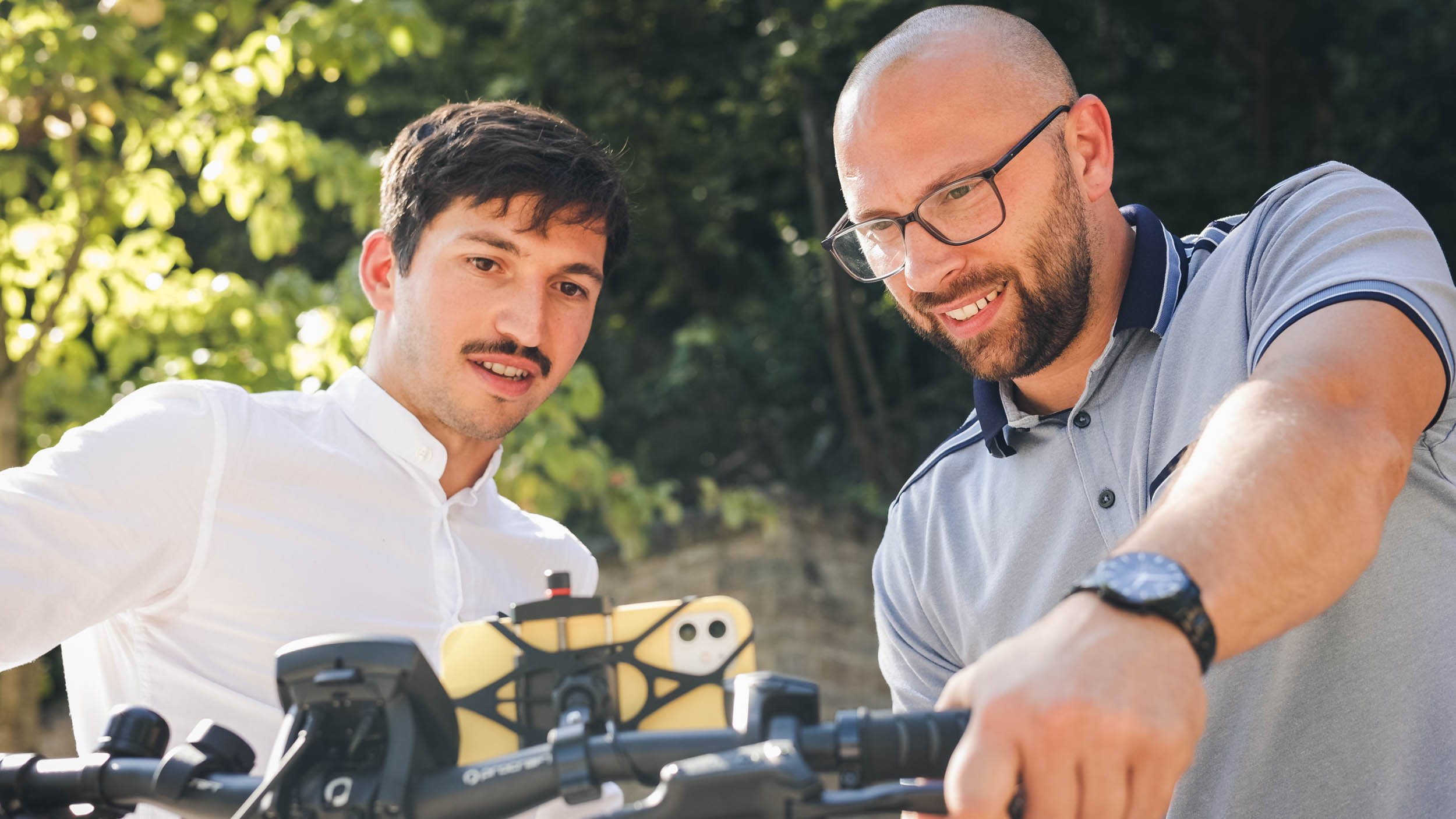 2 men with a bike handle with the vialytics phone attached