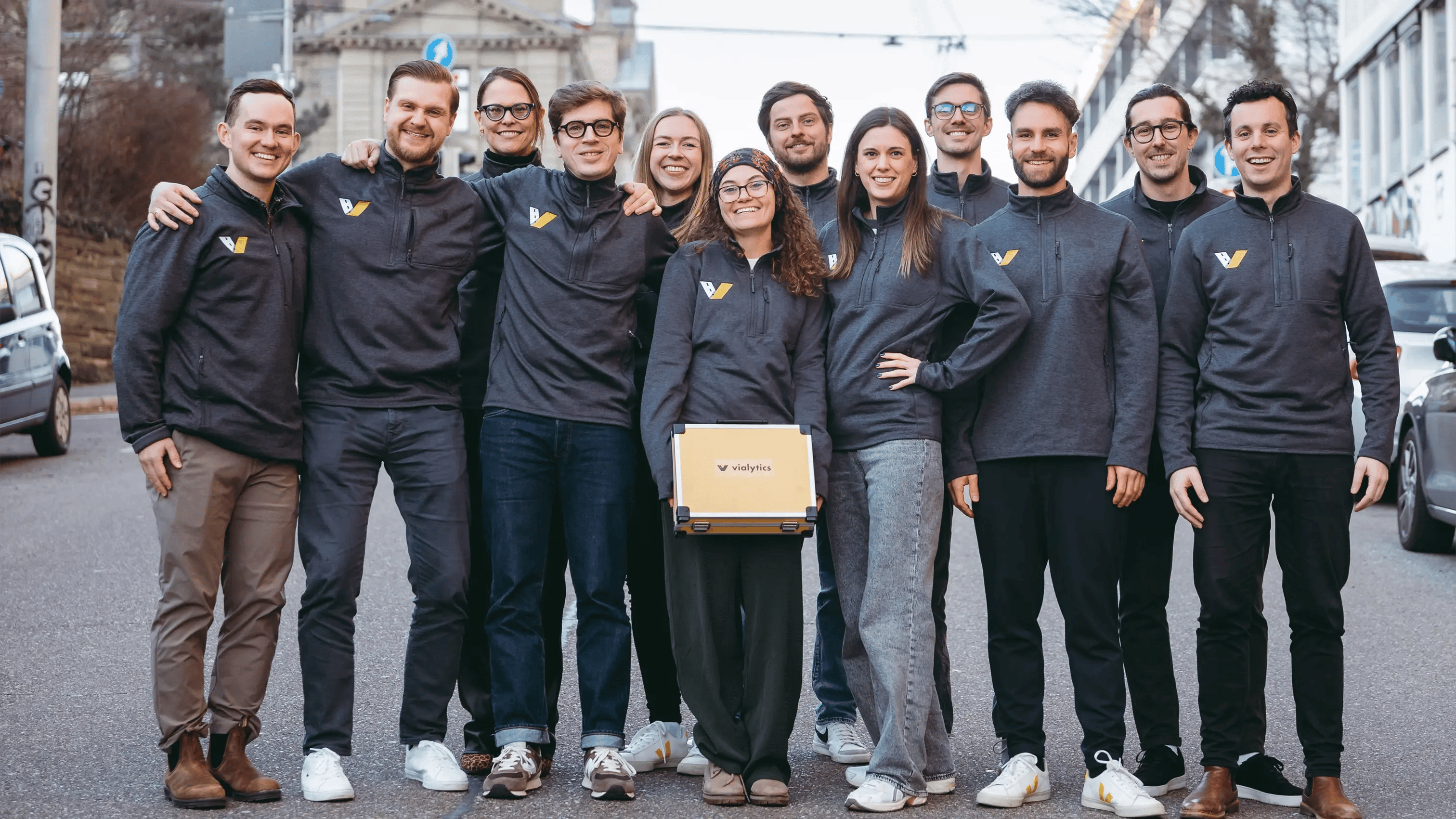 The Customer Success Service Team of vialytics standing together on a road. The people on the image are avialable to support the customers of vialytics.