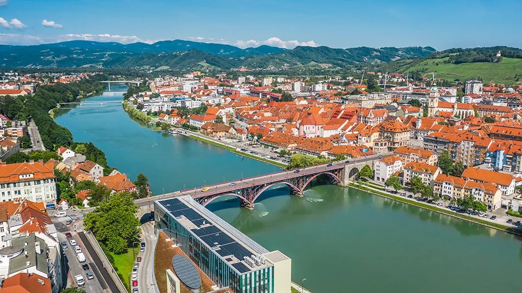 picture of the city of maribor from the top, showing a river and a bridge